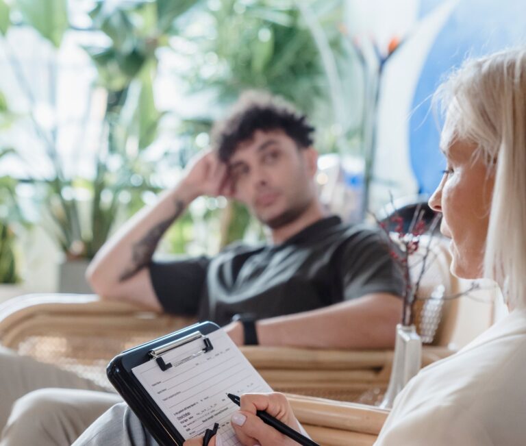 A coach reviewing an intake form while speaking with a participant