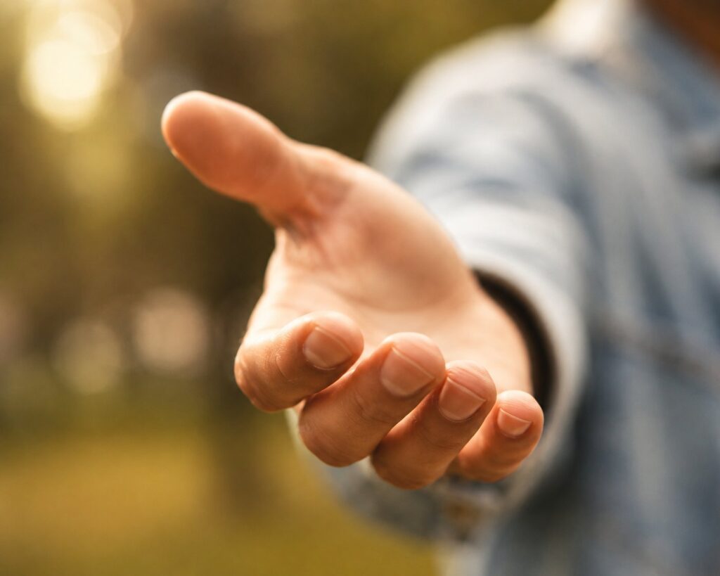 An open, outstretched hand, symbolizing reaching out and offering help